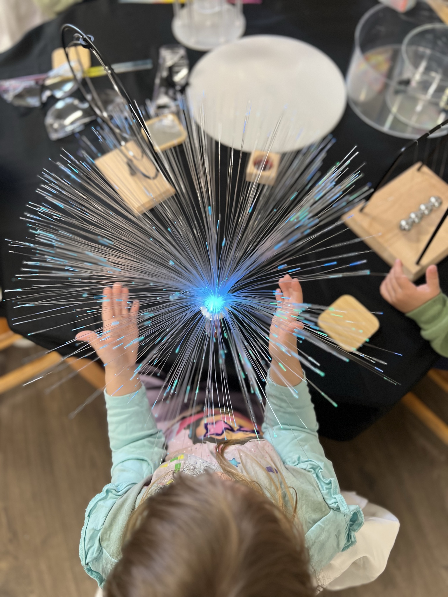Child exploring light and sensory materials at Lakeview Preschool